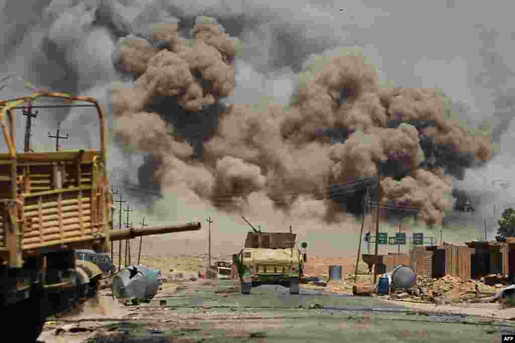 Smoke billows as Iraqi forces advance toward Al-Ayadieh village, the last remaining active frontline near Tal Afar, during an operation to retake the city from the Islamic State group, Aug. 29, 2017.