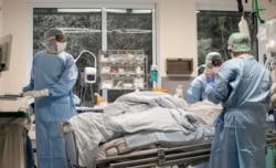 An intubated COVID-19 patient gets treatment at the intensive care unit at the Westerstede Clinical Center, a military-civilian hospital in Westerstede, northwest Germany, Dec. 17, 2021.