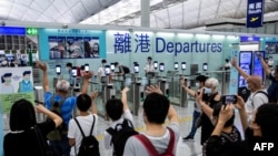 上世紀50到80年代許多中國人逃到香港追求自由生活，然而2020年7月香港國安法施行後，大批香港人開始逃離香港。圖為2021年7月22日香港國際機場出境大廳內許多民眾向離港親友揮手道別。