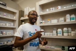 FILE: Luckymore Bhunu, secretary for the Retail Pharmacists Association, speaks with an AFP journalist in Harare on October 9, 2018, about drug shortage in Zimbabwe as many essential drugs, including those for diabetics and hypertensive patients, are in short supply.