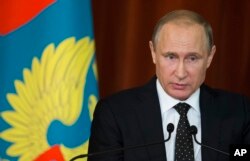 FILE - Russian President Vladimir Putin speaks during his meeting with Russian Ambassadors in Moscow, Russia, June 30, 2016.