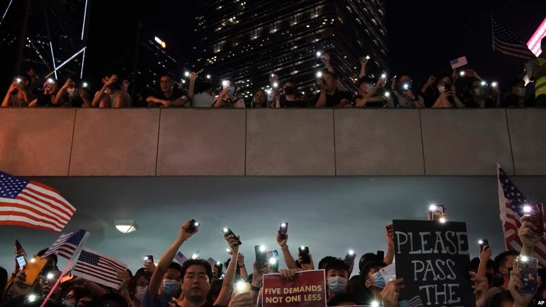 Protestors light their torches during a peaceful rally in central Hong Kong's business district, Oct. 14, 2019. 