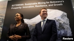 FILE - Chief Executive Officer at De Beers Group, Al Cook, right, and Botswana's Minister of Mineral and Energy, Bogolo Kenewendo, meet for talks on a diamond deal at the Investing in African Mining Indaba in Cape Town, South Africa, Feb. 3, 2025.