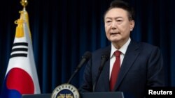 FILE - South Korean President Yoon Suk Yeol delivers an address to the nation from the Presidential Office in Seoul, South Korea, Dec. 7, 2024. On Tuesday, a South Korean court approved an arrest warrant for Yoon, who was impeached Dec. 14, 2024. (Presidential Office via Reuters)