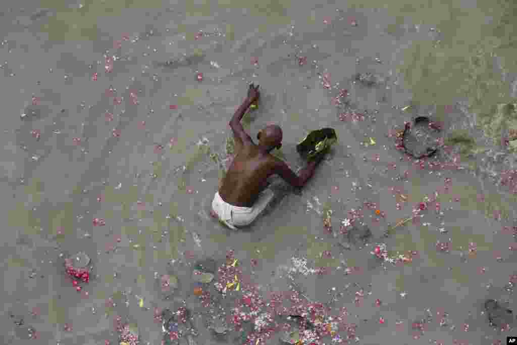 A Hindu devotee performs "Pind Daan", rituals for the soul of ancestors in the river Ganges at Phaphamau, Allahabad, India.