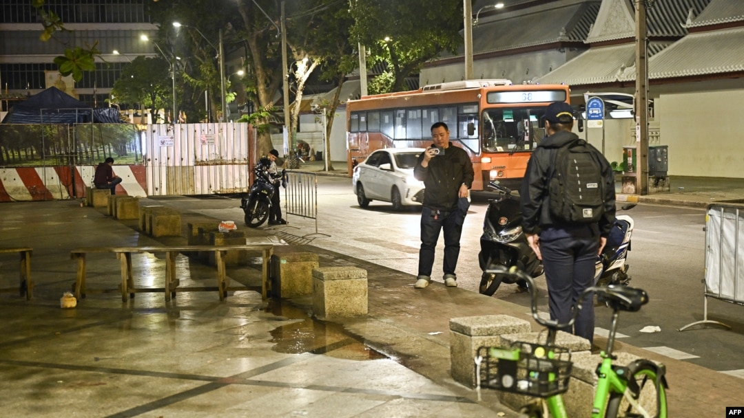 Central Investigation Bureau members stand near the spot where a former Cambodian MP was reportedly shot dead by a man on a motorbike in Bangkok, Thailand, Jan. 7, 2025. 