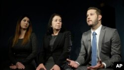 FILE - Christine Levinson (center) wife of Robert Levinson, and her children, Dan and Samantha Levinson, talk to reporters in New York, Jan. 18, 2016.