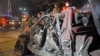 Soldiers stand near the wreckage of a suicide car bomb outside Somalia's presidential palace, Sept, 21, 2015.