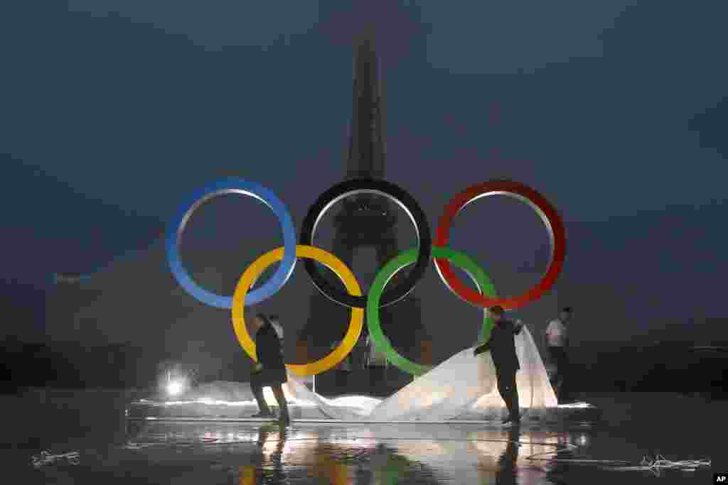 Paris officials unveil a display of the Olympic rings on Trocadero plaza that overlooks the Eiffel Tower, after the vote in Lima, Peru, awarding the 2024 Games to the French capital, in Paris, France.
