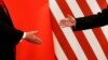 FILE - U.S. President Donald Trump and China's President Xi Jinping shake hands after making joint statements at the Great Hall of the People in Beijing, Nov. 9, 2017. 