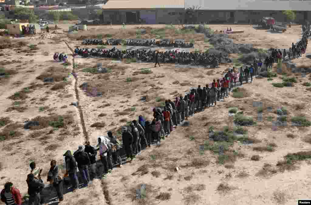 Migrants wait to be transported to a detention center, in the coastal city of Sabratha, Libya, Oct. 7, 2017.