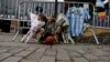 An Argentinian national team jersey hangs at a memorial on West Street two days after a man driving a rented pickup truck mowed down pedestrians and cyclists on a bike path alongside the Hudson River, in New York, Nov. 2, 2017. 