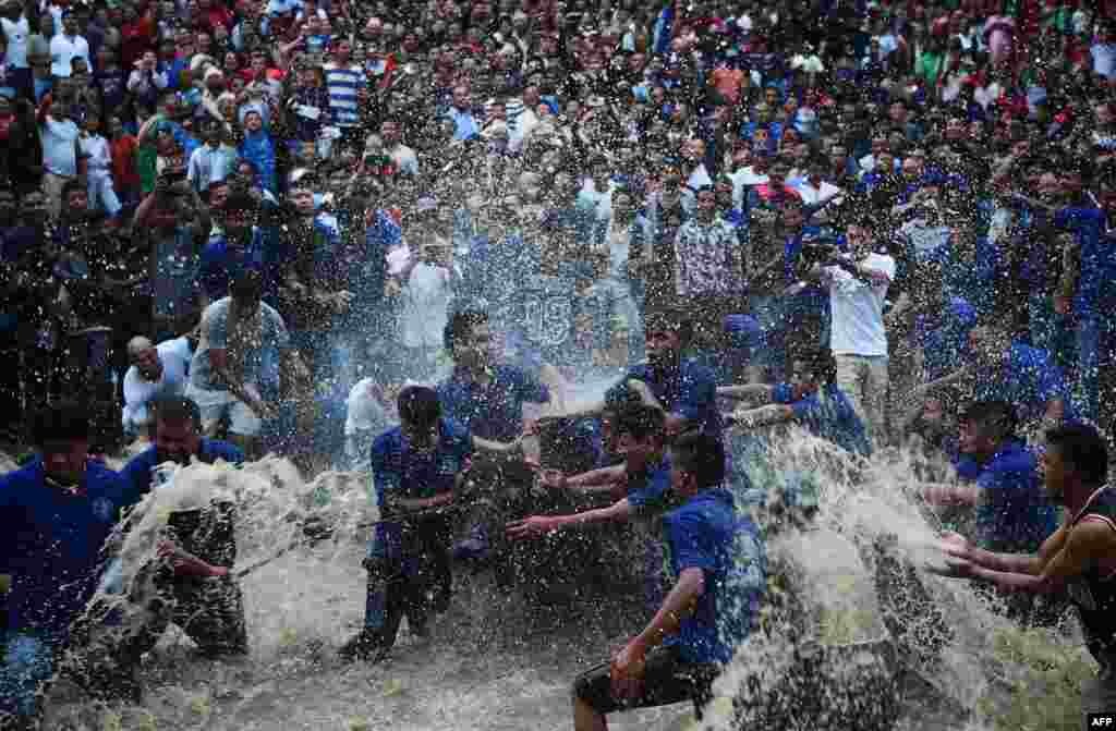 Nepali Hindu devotees splash water on a buffalo set to be sacrificed during the Hindu Dashain Festival in Bhaktapur, on the outskirts of Kathmandu.