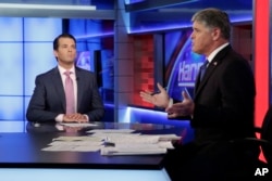 FILE - Donald Trump Jr. is interviewed by host Sean Hannity on his Fox News Channel television program, in New York, July 11, 2017.