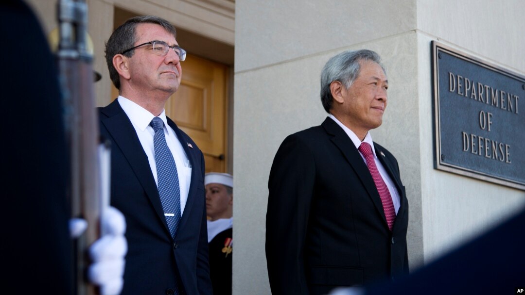 Secretary of Defense Ash Carter and Singapore's Minister of Defense Ng Eng Hen, listen as the national anthem of Singapore and the United States are played during an honor cordon at the Pentagon, Dec. 7, 2015. 