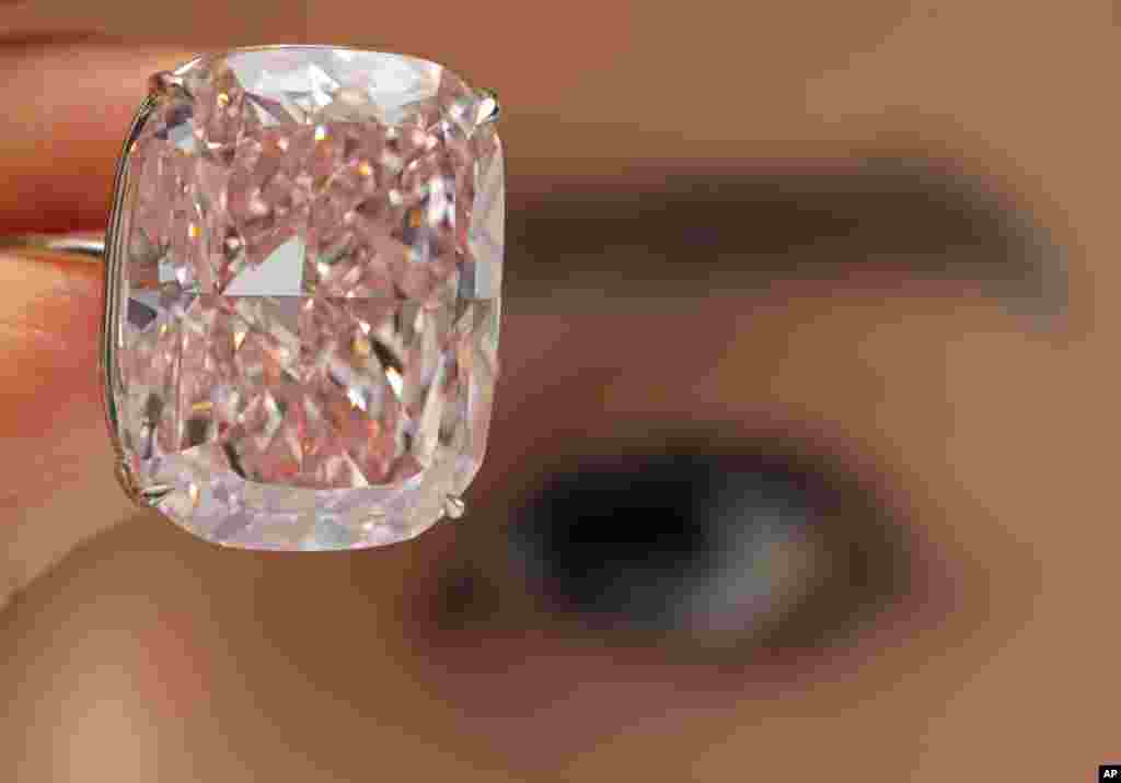 A 37.30-carat diamond "The Raj Pink" is displayed by a model at a Sotheby's auction room in Hong Kong.
