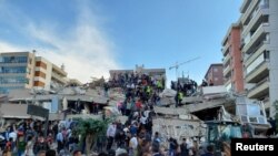 Meštani i zvaničnici tragaju za preživelima u srušenoj zgradi nakon što je snažan zemljojtres nastao u Egejskom moru u petak, a osetio se i u Grčkoj i Turskoj. 
