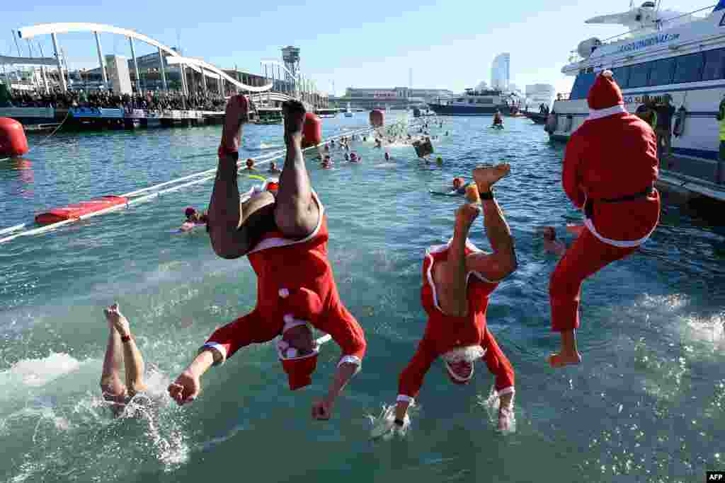 Participants in a Santa Claus costume jump into the water during the 110th edition of the 'Copa Nadal' (Christmas Cup) swimming competition in Barcelona's Port Vell, Spain.