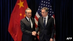 美国国务卿布林肯(右)在2023年7月13日在雅加达举行东盟外长会议期间与中共中央外事工作委员会办公室主任王毅握手. (法新社)