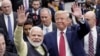 FILE - Indian Prime Minister Narendra Modi and U.S. President Donald Trump walk the perimeter of the arena floor to greet attendants after Modi's speech during the "Howdi Modi" event on Sept. 22, 2019, at NRG Stadium in Houston, Texas.