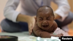 Pietro Rafael, who has microcephaly, reacts to stimulus during an evaluation session with a physiotherapist at the Altino Ventura rehabilitation center in Recife, Brazil, Jan. 28, 2016. 