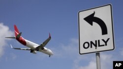 FILE - A Qantas plane prepares to land at Sydney Airport, at Sydney, Australia, Feb. 21, 2013. 