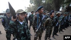 Karen National Union (KNU) soldiers hold their assault weapons as they parade during the celebration of the 63rd anniversary of the Karen Revolution day at Oo Kray Kee village in Karen State, near the Thai-Myanmar border on January 31, 2012. The KNU is w