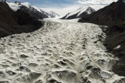 Meltwater flows over the Laohugou No. 12 glacier in the Qilian mountains, Subei Mongol Autonomous County in Gansu province, China. Glaciers in the bleak, rugged Qilian mountains are disappearing at a shocking rate.