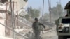 An Iraqi soldier runs through the city of Qaraqosh, as troops search for any Islamic State militants still in the area, near Mosul in Iraq, Oct. 30, 2016. 