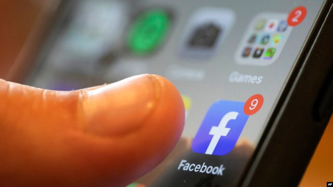 FILE - An iPhone displays the Facebook app in New Orleans, Aug. 11, 2019. 
