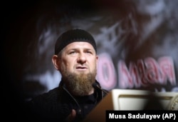CHECHNYA -- Chechen leader Ramzan Kadyrov speaks in front of a portrait of his father Akhmad Kadyrov, the Chechen president who was assassinated in a 2004 bomb blast, during a meeting in Grozny, May 10, 2019