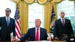 President Donald Trump listens to a reporter's question after signing an executive order to increase sanctions on Iran, June 24, 2019..