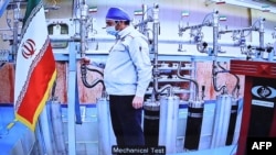 A handout picture provided by the Iranian presidential office on Apr. 10, 2021 shows a grab of a videoconference screen of an engineer inside Iran's Natanz uranium enrichment plant, shown during a ceremony. (AFP photo/Ho/Iranian Presidency)