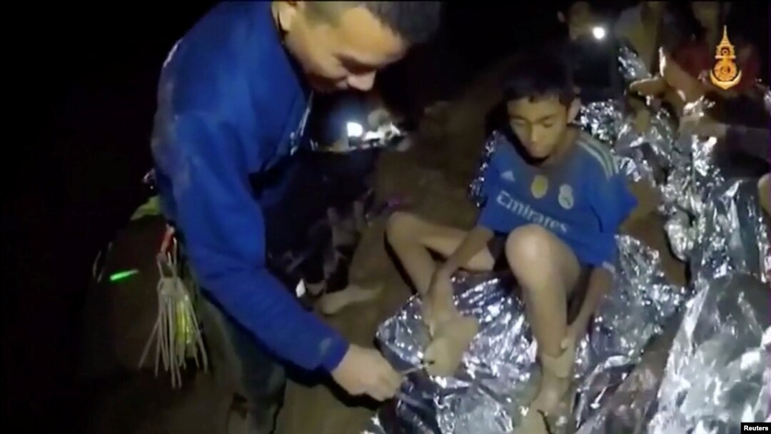 Boys from the under-16 soccer team trapped inside Tham Luang cave receive treatment from a medic in Chiang Rai, Thailand, in this still image taken from a July 3, 2018 video by Thai Navy Seal.