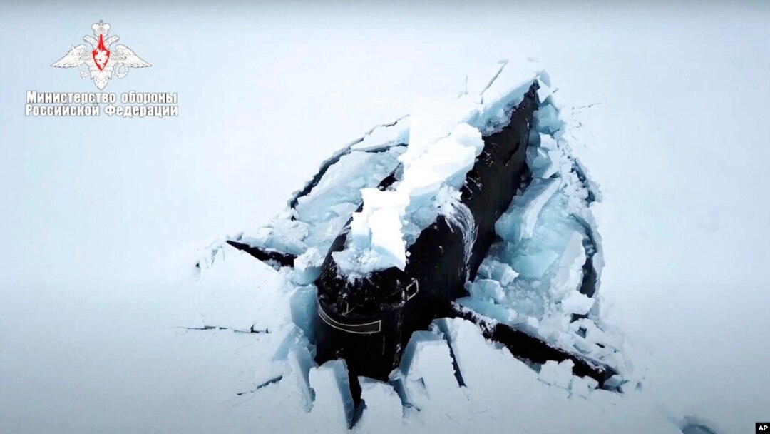 A Russian nuclear submarine breaks through the Arctic ice during military drills at an unspecified location, March 26, 2021, in this handout photo taken from a footage released by Russian Defense Ministry Press Service.