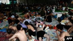 ภาพที่บันทึกเมื่อ 23 ก.พ. 2568 ระบุว่า คนงานและเหยื่อของแก๊งคอลเซนเตอร์ที่กองกำลังติดอาวุธรักษาชายแดนของกะเหรี่ยง หรือ BGF ทลายและช่วยเหลือออกมา นอนพักผ่นที่บริเวณจุดข้ามแดนเมียนมา-ไทย ที่เมืองเมียวดี