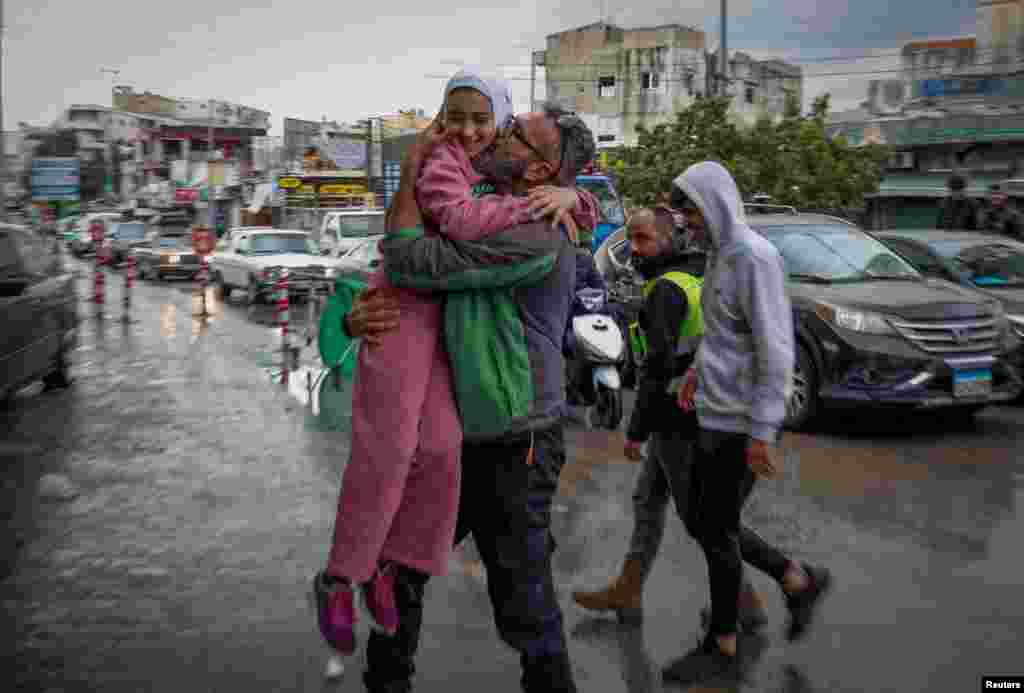 Mohammed Sleem hugs his daughter Menisa Sleem as he meets her after two months, according to Mohammed, after a cease-fire between Israel and Iran-backed group Hezbollah took effect, in Tyre, Lebanon. U.S. President Joe Biden said both sides accepted an agreement brokered by the United States and France.