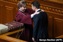 UKRAINE -- Volodymyr Zelenskiy receives presidential symbols from Natalia Shaptala, Chairman of the Constitutional Court of Ukraine, during his inauguration ceremony at the parliament in Kyiv, May 20, 2019