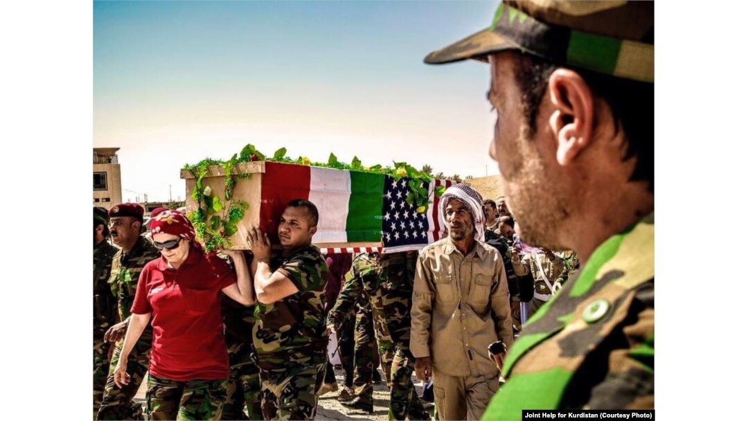 FILE - People carry the coffin of American volunteer Leland Scott during burial ceremony in Sharfadin shrine, Duhok, Iraq, June 21, 2016.