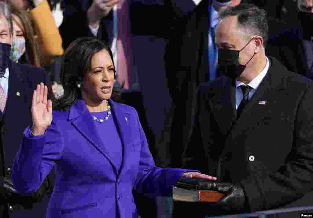 Kamala Harris is sworn in as U.S. Vice President as her spouse Doug Emhoff holds a bible during the inauguration of Joe Biden as the 46th President of the United States on the West Front of the U.S. Capitol in Washington, U.S., January 20, 2021. REUTERS/Kevin Lamarque