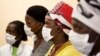 FILE - Patients with tuberculosis (TB) and HIV wear masks while awaiting consultation at a clinic in Cape Town's Khayelitsha township, South Africa.