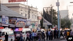 Ambulances and security forces gather on the street outside the Hotel Afrik in Mogadishu, Somalia, Jan. 31, 2021.