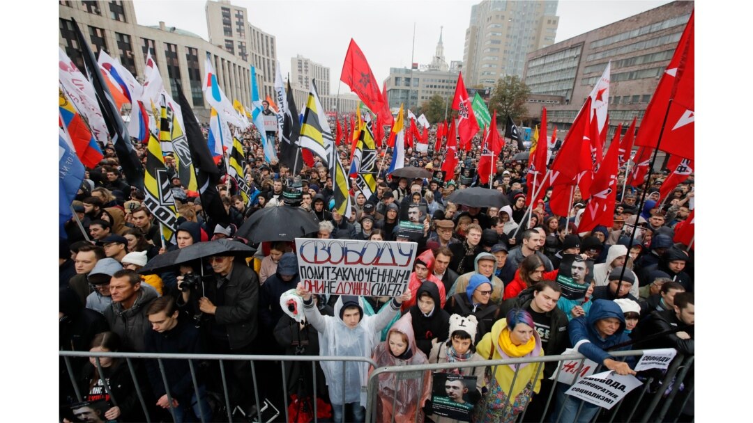 FILE - A protester holds a banner reading "Freedom to political prisoners!" during a rally in Moscow, Russia, Sept. 29, 2019.