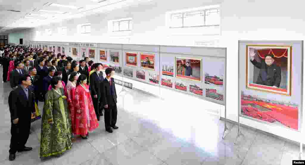 People view a photo exhibit marking the 20th anniversary of Kim Jong Il's election to general secretary of the Workers' Party of Korea, at the People's Palace of Culture, in this photo released by North Korea's Korean Central News Agency.