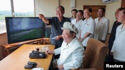 FILE PHOTO: North Korea's Kim Jong Un oversees drone test