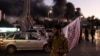 Smoke billows as people gather to celebrate the fall of the Syrian government, in Damascus, Syria, Dec. 8, 2024.
