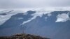 Seorang pria berhenti di puncak yang sebelumnya adalah gletser Okjokull, Islandia, 18 Agustus 2019. 