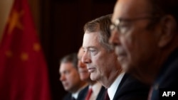 US Trade Representative Robert Lighthizer (C) and US Secretary of Commerce Wilbur Ross (R) talk with the Chinese Delegation, including Vice Premier Liu He, during US-China Trade Talks in Washington, DC, on January 30, 2019.