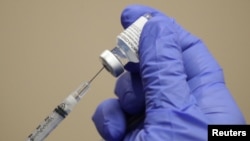 FILE - A healthcare worker draws the coronavirus disease (COVID-19) vaccine from a vial at Dignity Health Glendale Memorial Hospital and Health Center in Glendale, California, Dec. 17, 2020. 