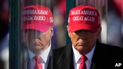 FILE - U.S. President-elect Donald Trump is reflected in bulletproof glass as he finishes speaking at a campaign rally in Lititz, Pennsylvania, Nov. 3, 2024. Trump's transition team said on Dec. 13, 2024, that "maximum pressure" is possible in regard to Iran's nuclear ambitions.